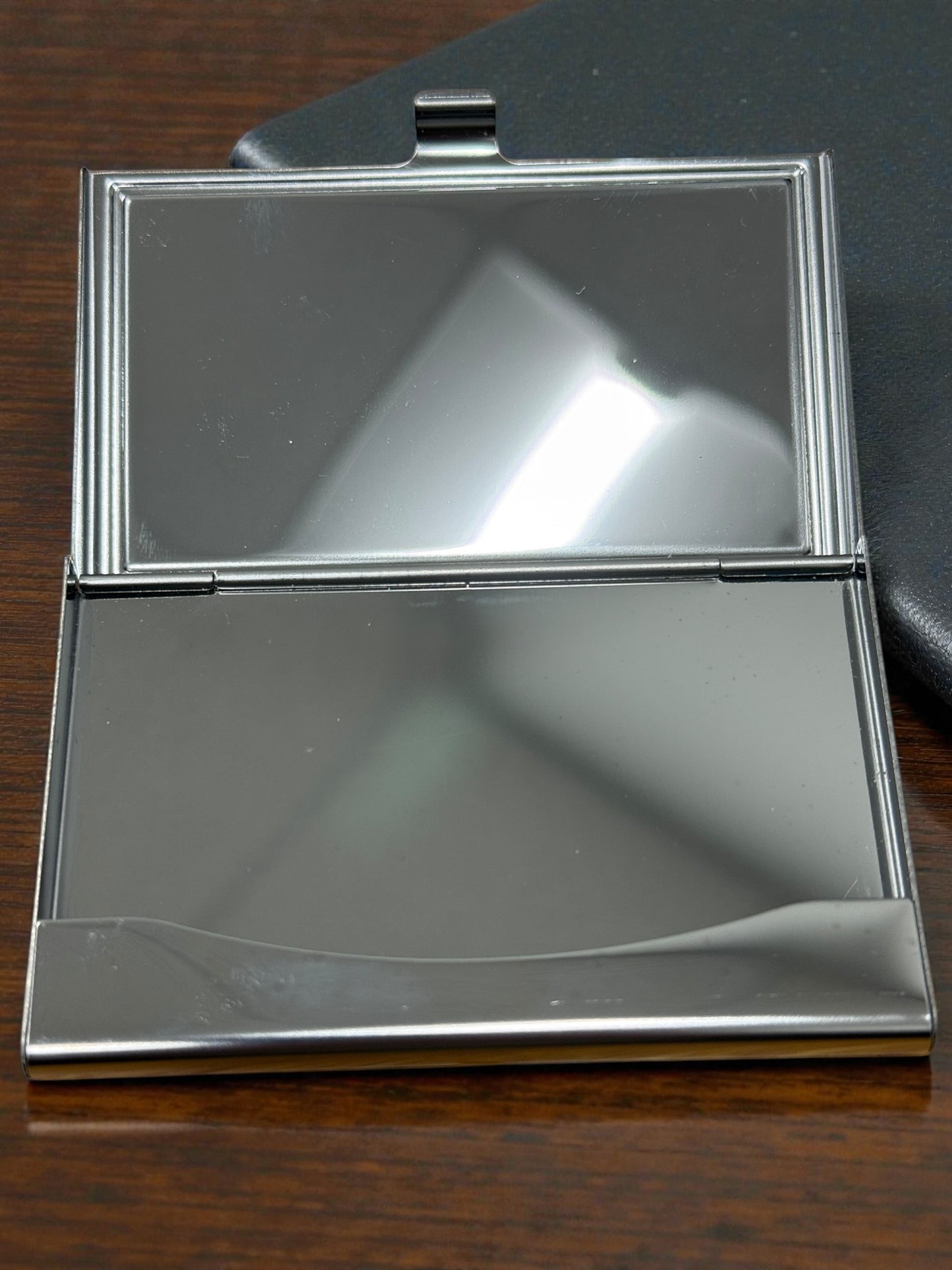 Wood and metal business card holder by Bunkers Workshop, with sleek design and multiple slots for organizing business cards.